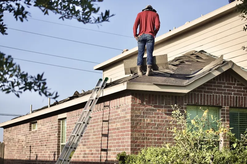 Professional roofer working on a residential roof in Pohick